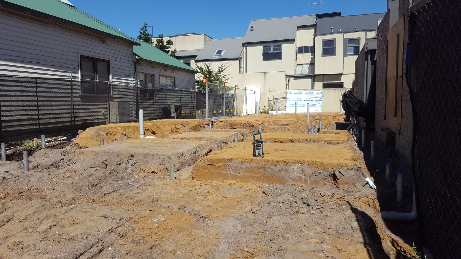 Screw pile heads with beam trenches dug between them