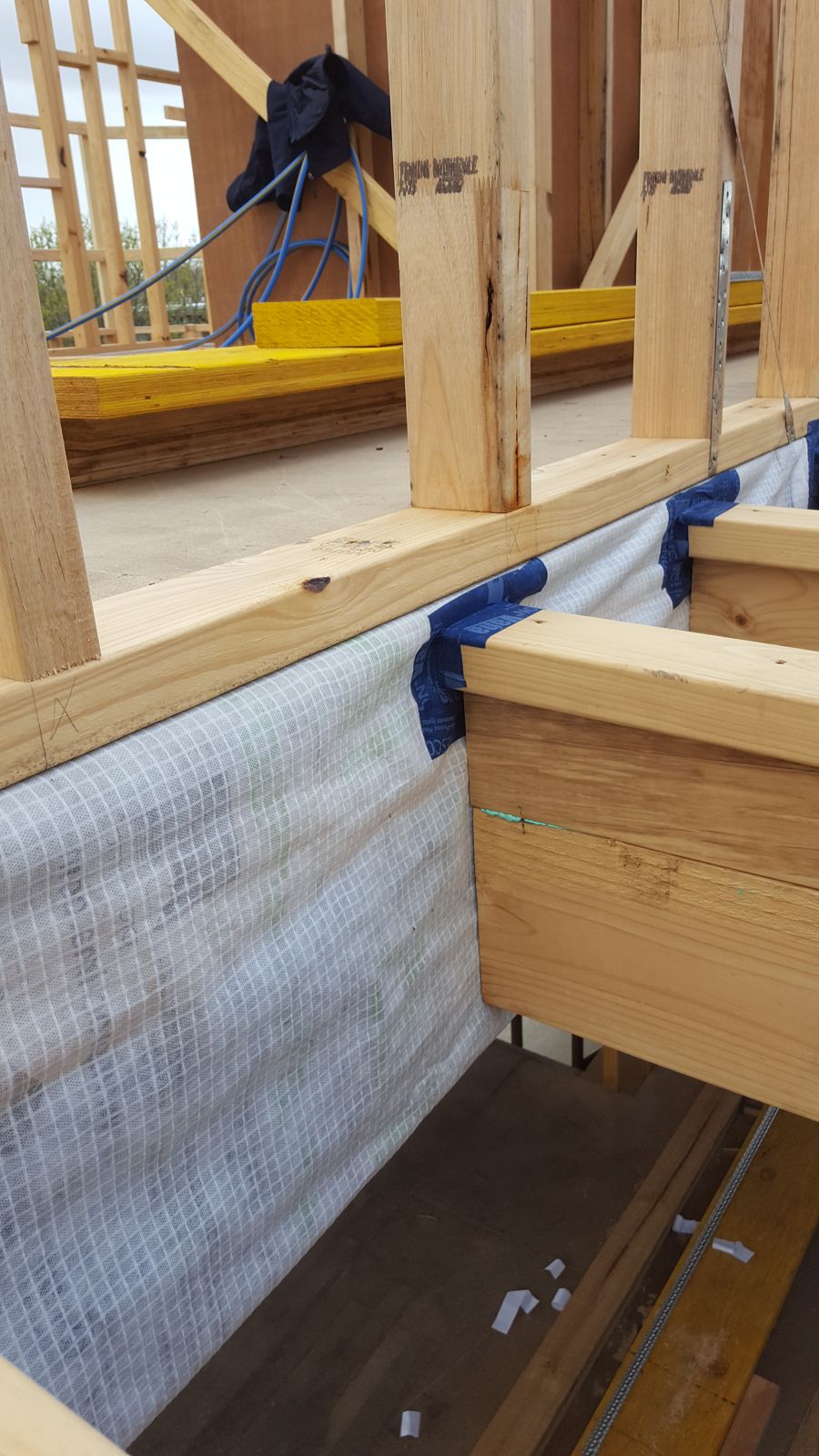 Airtight membrane wrapped through the floor zone before the floor framing closes in