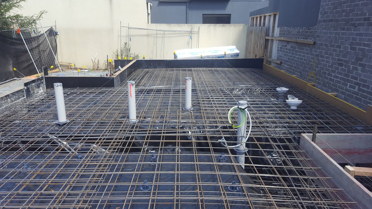 Slab steel, plumbing and electrical services in place before the concrete pour